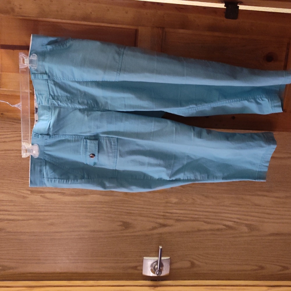 Brand is docker's, size 14, and the color is teal
